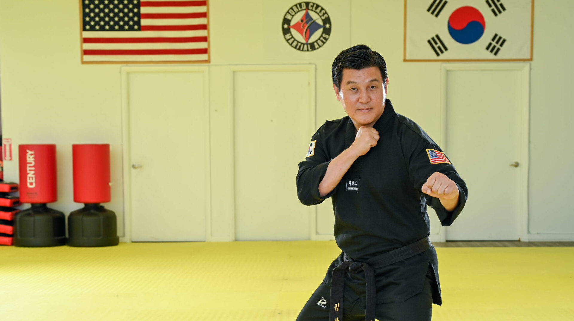 Sangwon Jeong stands in a fighting stance with one fist in front of his chest and another in front of his body.