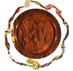 Opón Ifá, mazo for Orúnmila and opele (divination chain). Adrian Castro. Opón Ifá loaned by Babalawo Eugenio Villar. Mazo: HMSF Collection, 2001.7.1. Opele loaned by Adrian Castro.