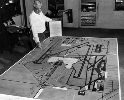 Dade County Port Authority Director A. B. Curry looks over Miami International Airport expansion plan drawings. 1950. Photo by Ralph Kestly. Miami News Collection, Museum of Miami. 1989-011-10041.