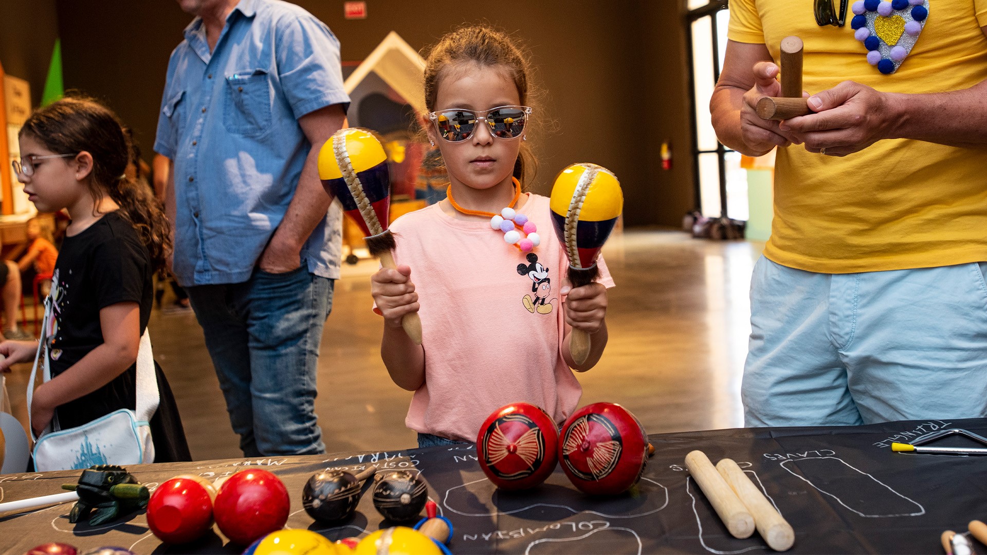 Girl holding maracas.