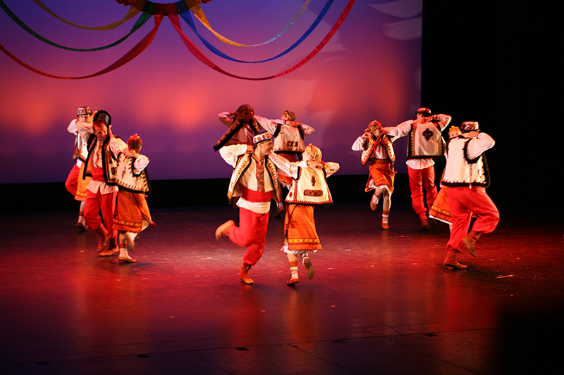 dancers perform on stage in pairs