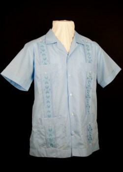 Embroidered guayabera. 2012. Poly-cotton. Guayaberas, Etc. Manufactured in Merida, this guayabera is a typical example of a machine-embroidered Mexican version of the shirt. Perhaps the best-known Mexican contribution to the garment is the vertical stripes of embroidery that decorate its front. Embroidered guayaberas are popular with consumers in various locales, including the U.S. Collection of Museum of Miami. Gift of Guayaberas, Etc. Embroidered guayabera. 2012. Poly-cotton. Guayaberas, Etc. Manufactured in Merida, this guayabera is a typical example of a machine-embroidered Mexican version of the shirt. Perhaps the best-known Mexican contribution to the garment is the vertical stripes of embroidery that decorate its front. Embroidered guayaberas are popular with consumers in various locales, including the U.S. Collection of Museum of Miami. Gift of Guayaberas, Etc.