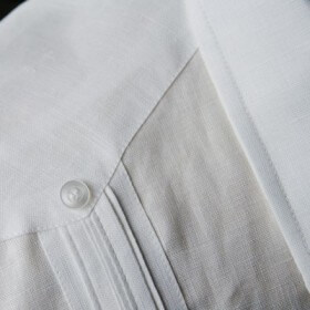 Stripes of pleating and/or embroidery adorn the guayabera.