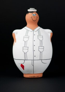 Tourist items featuring the guayabera. Circa 2012. Tourist shops in Merida sell a variety of merchandise featuring the guayabera. These souvenirs include banks, ashtrays, tic-tac-toe games, nativity scenes, toys and other items. Collection of Museum of Miami. Tourist items featuring the guayabera. Circa 2012. Tourist shops in Merida sell a variety of merchandise featuring the guayabera. These souvenirs include banks, ashtrays, tic-tac-toe games, nativity scenes, toys and other items. Collection of Museum of Miami.
